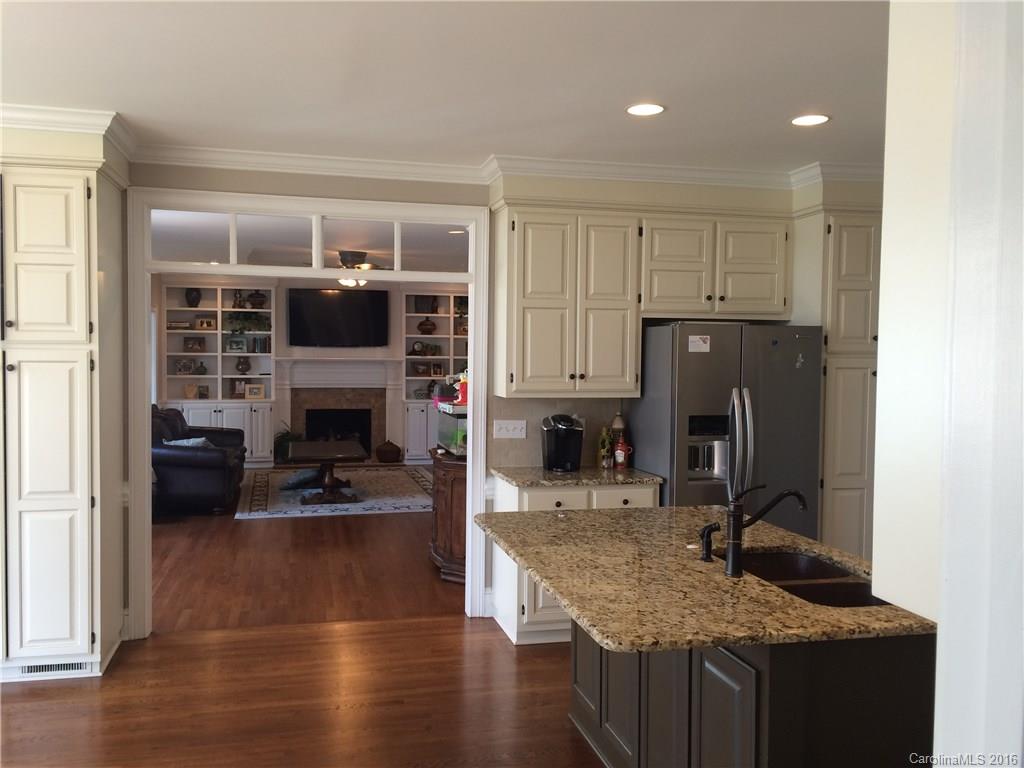 4732 Binfords Ridge Road Charlotte, NC 28226 - Photo 5 of 13 a kitchen with furniture and a fireplace