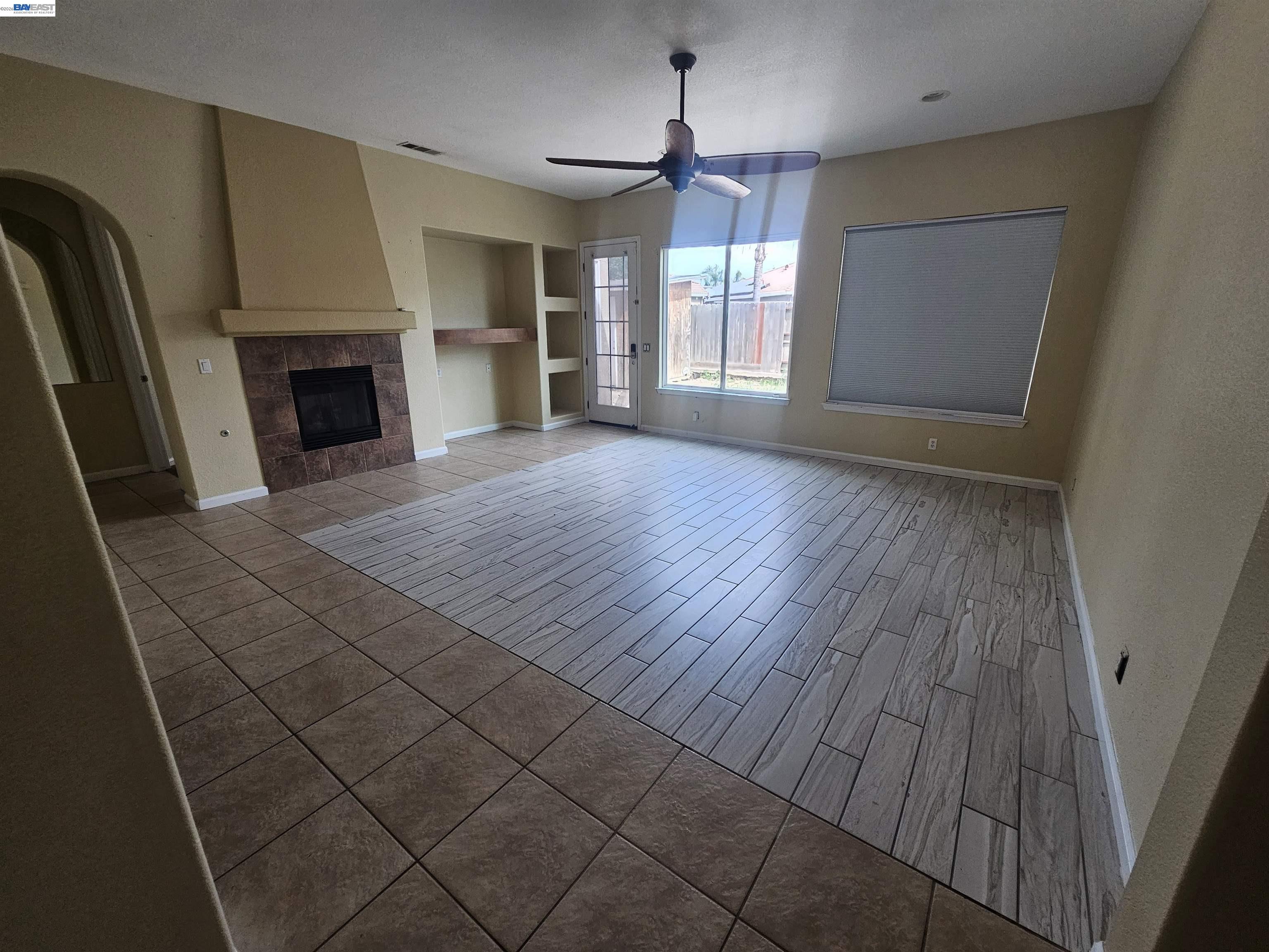 537 Bonanza Drive Newman, CA 95360 - Photo 3 of 16 an empty room with windows and fireplace