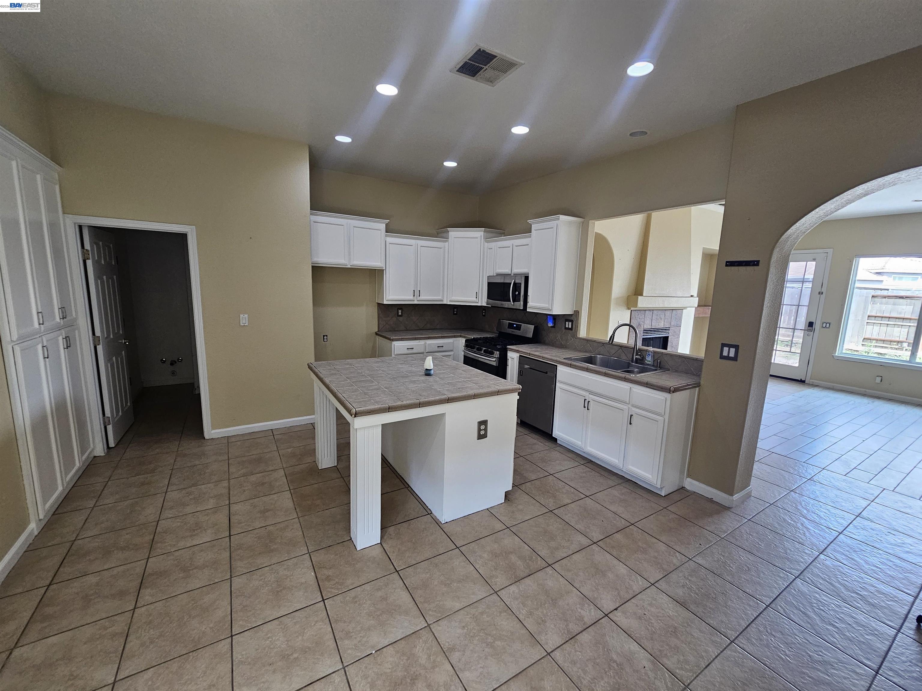 537 Bonanza Drive Newman, CA 95360 - Photo 5 of 16 a kitchen with stainless steel appliances granite countertop a stove a sink and a refrigerator