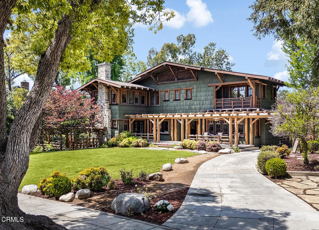 a front view of a house with a garden