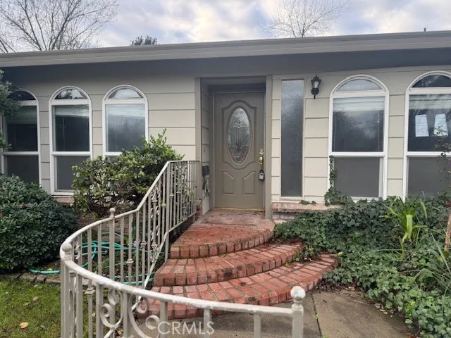 a front view of a house with a garden