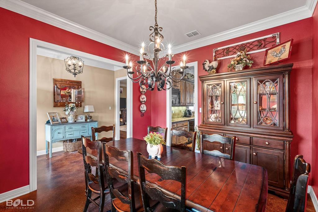 13870 Highway 157 Haughton, LA 71037 - Photo 14 of 40 a view of a dining room with furniture a chandelier and wooden floor