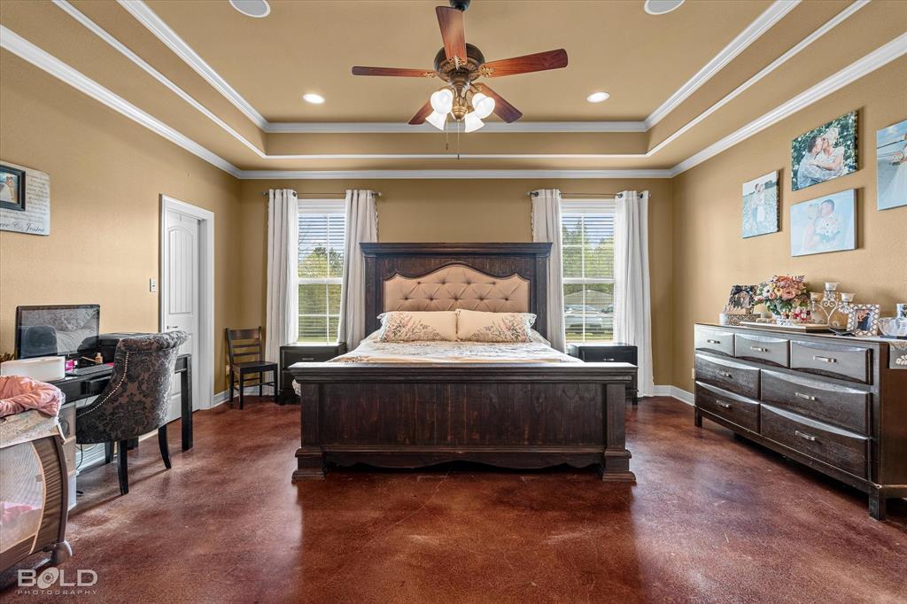 13870 Highway 157 Haughton, LA 71037 - Photo 18 of 40 a spacious bedroom with a bed and a chandelier