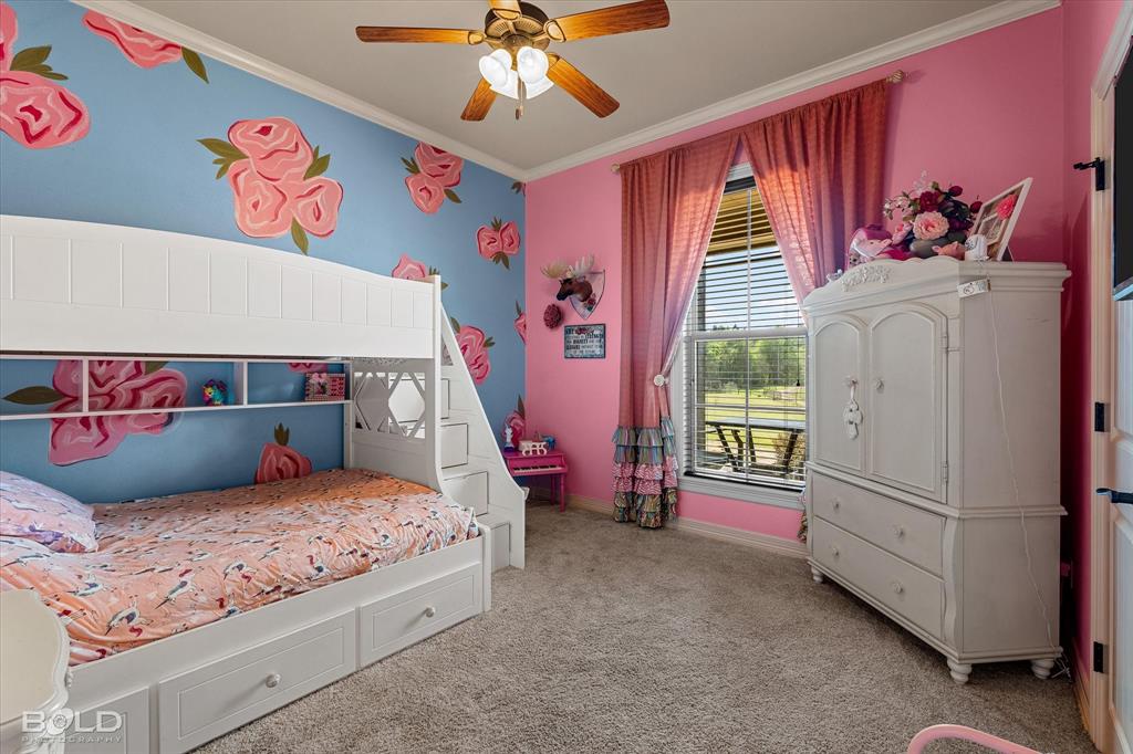 13870 Highway 157 Haughton, LA 71037 - Photo 22 of 40 a bedroom with a bed and a chandelier