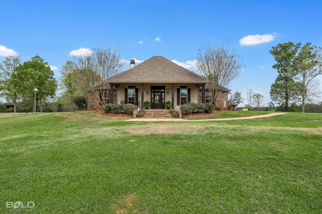 13870 Highway 157 Haughton, LA 71037 - Photo 4 of 40 a front view of a house with garden and trees