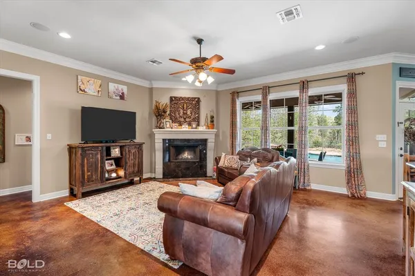 a living room with furniture a flat screen tv and a fireplace
