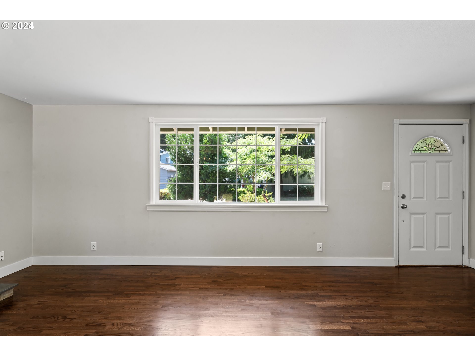 1320 Menlo Loop Springfield, OR 97477 - Photo 11 of 43 a view of an empty room with wooden floor and a window