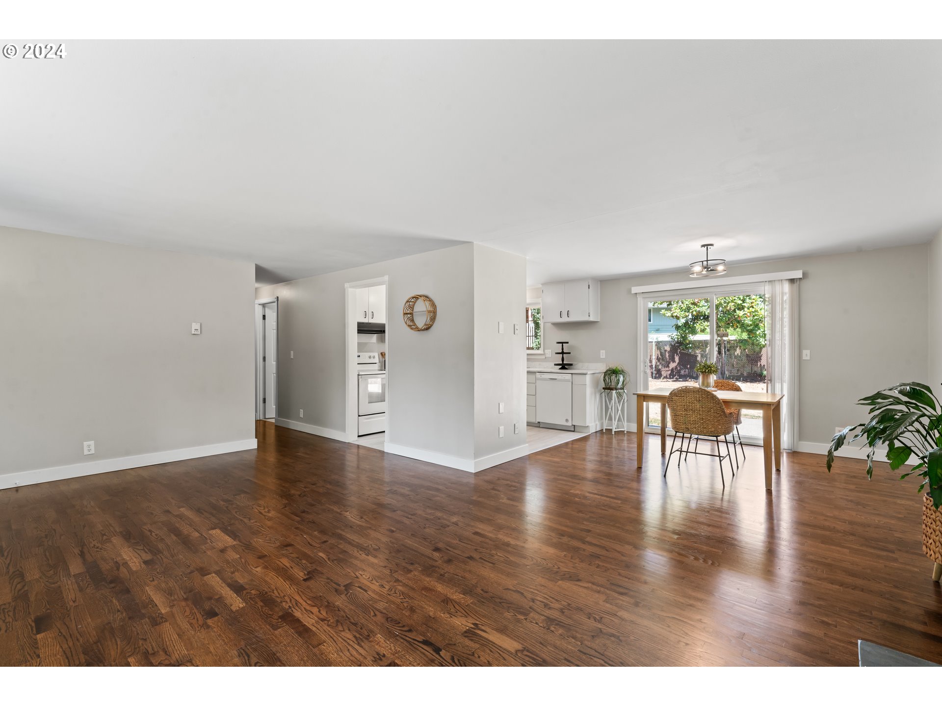 1320 Menlo Loop Springfield, OR 97477 - Photo 13 of 43 a view of an empty room with wooden floor and a window