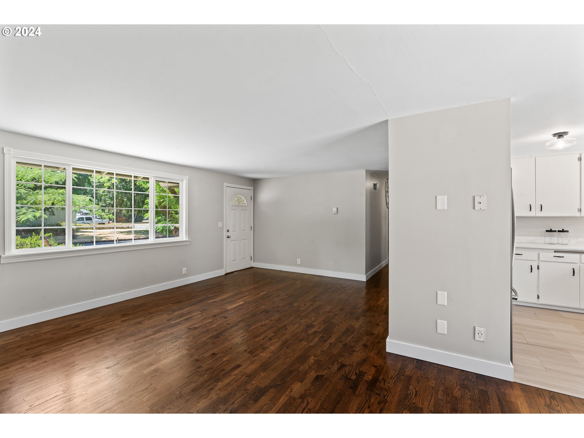 1320 Menlo Loop Springfield, OR 97477 - Photo 20 of 43 a view of an empty room with wooden floor and a window