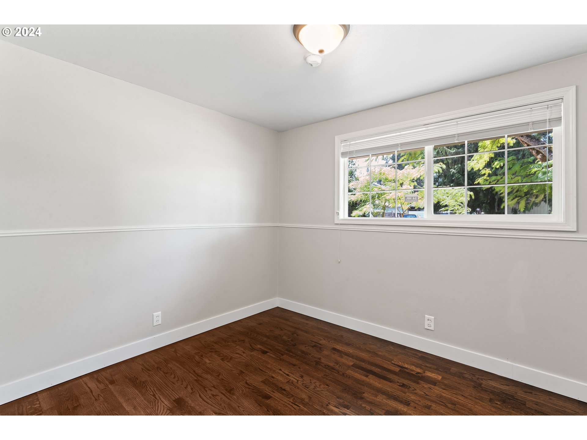 1320 Menlo Loop Springfield, OR 97477 - Photo 22 of 43 an empty room with wooden floor and windows