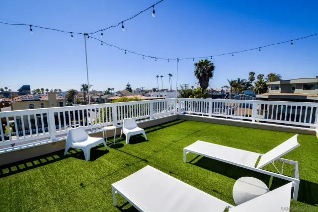 a view of a chairs and tables on the roof deck