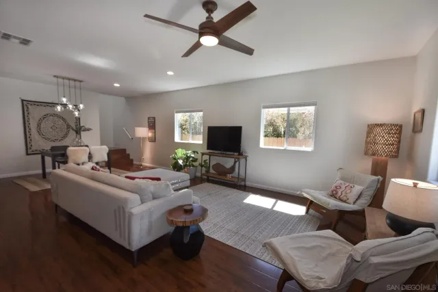 a living room with furniture or chandelier and a flat screen tv