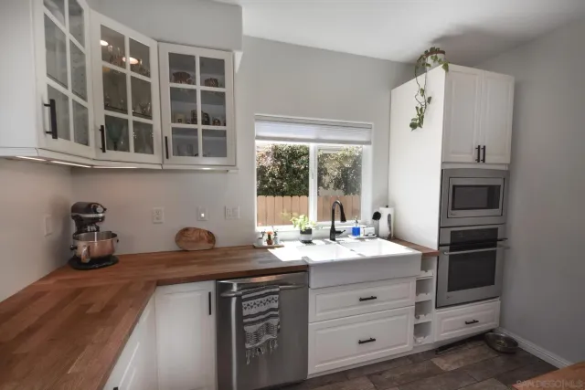 a kitchen with a sink stove and microwave