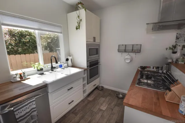 a kitchen with a sink stove and refrigerator