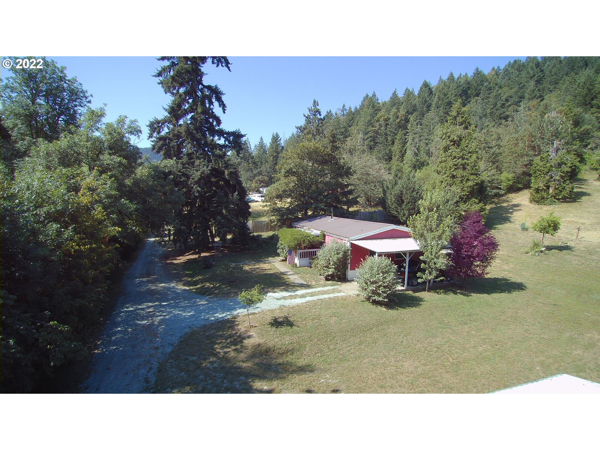 202 Homestake Lane Riddle, OR 97469 - Photo 25 of 31 a backyard of a house with a yard and outdoor seating