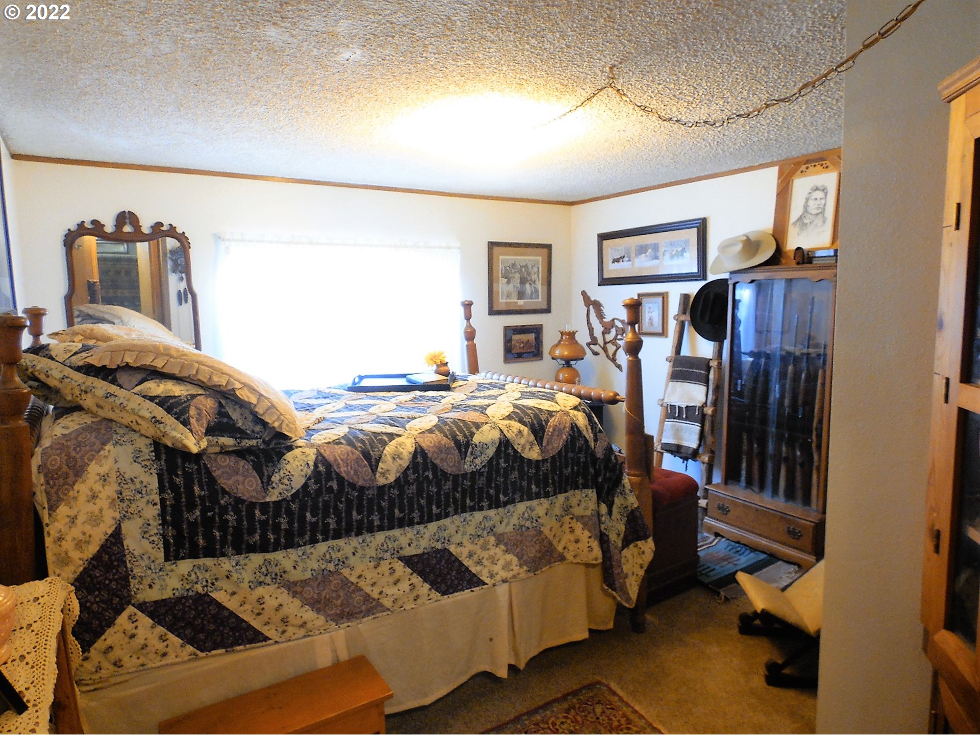 202 Homestake Lane Riddle, OR 97469 - Photo 7 of 31 a bedroom with a bed and wooden floor