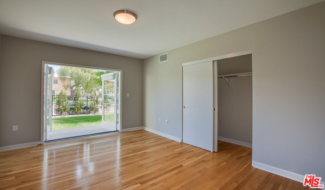 1012 Frederick Street, Unit 1 Venice, CA 90291 - Photo 5 of 10 a view of an empty room with wooden floor and a window