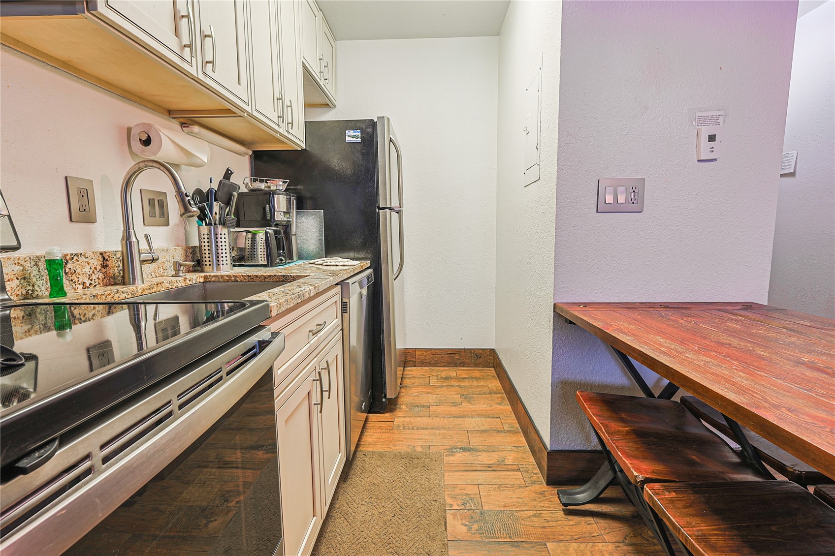 214 Ten Mile Circle, Unit R310 Copper Mountain, CO 80443 - Photo 5 of 15 a hallway with stainless steel appliances granite countertop a stove and cabinets