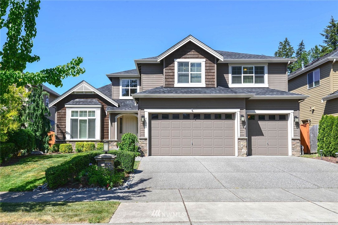 4423 220th Street Southeast Bothell, WA 98021 - Photo 1 of 24 a front view of a house with a yard and garage