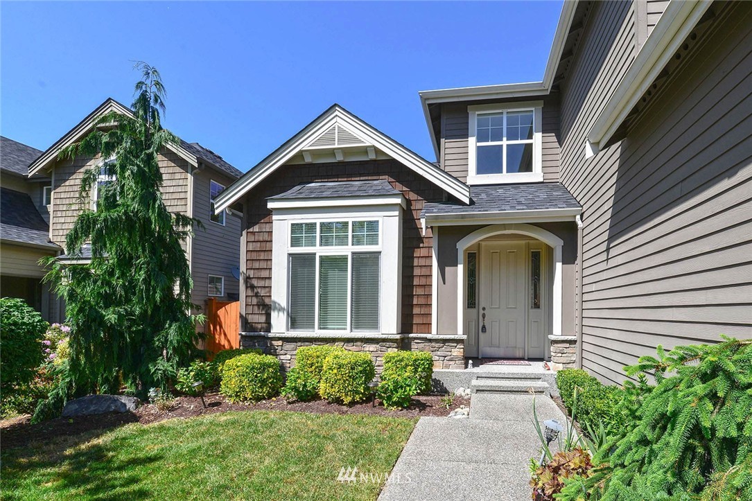 4423 220th Street Southeast Bothell, WA 98021 - Photo 2 of 24 a front view of a house with a yard