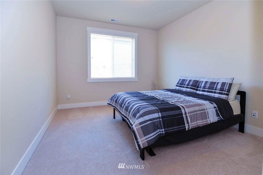 4423 220th Street Southeast Bothell, WA 98021 - Photo 12 of 24 a bedroom with a bed and window