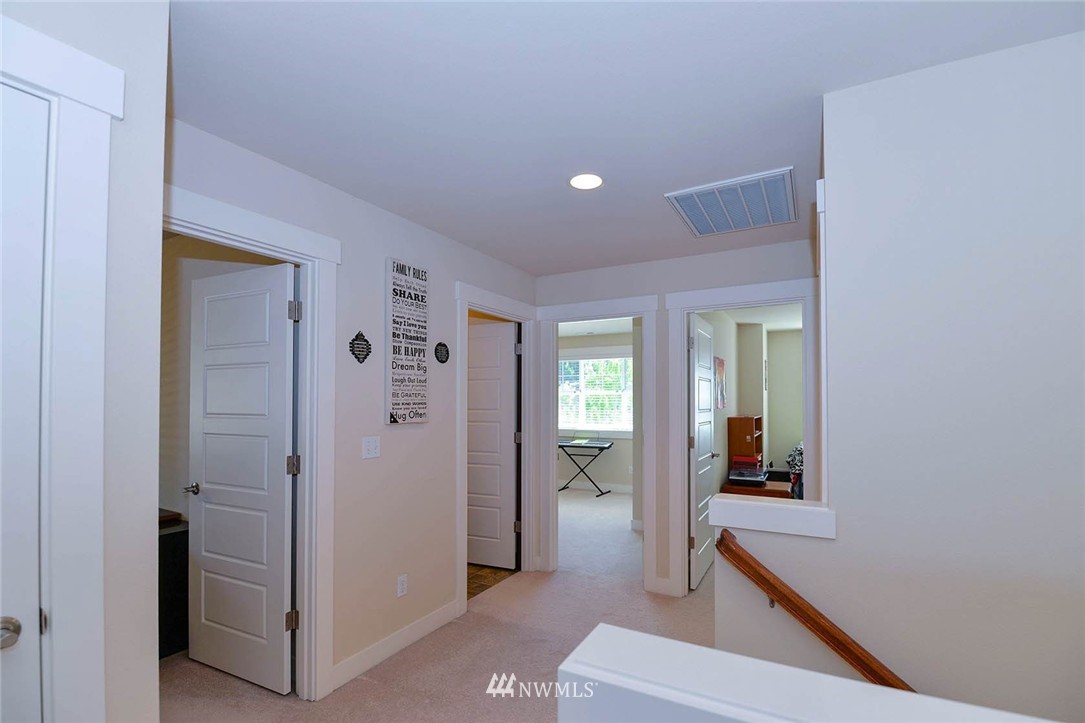 4423 220th Street Southeast Bothell, WA 98021 - Photo 15 of 24 a view of a hallway with bathroom and glass door