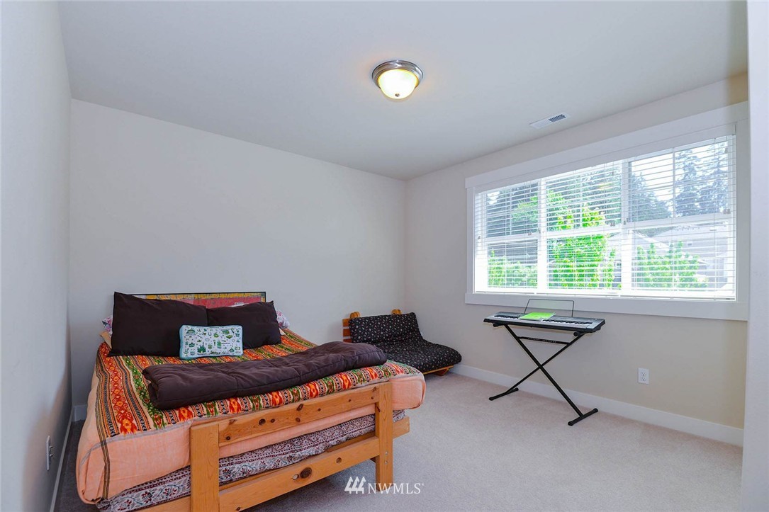 4423 220th Street Southeast Bothell, WA 98021 - Photo 18 of 24 a bedroom with a bed and a window