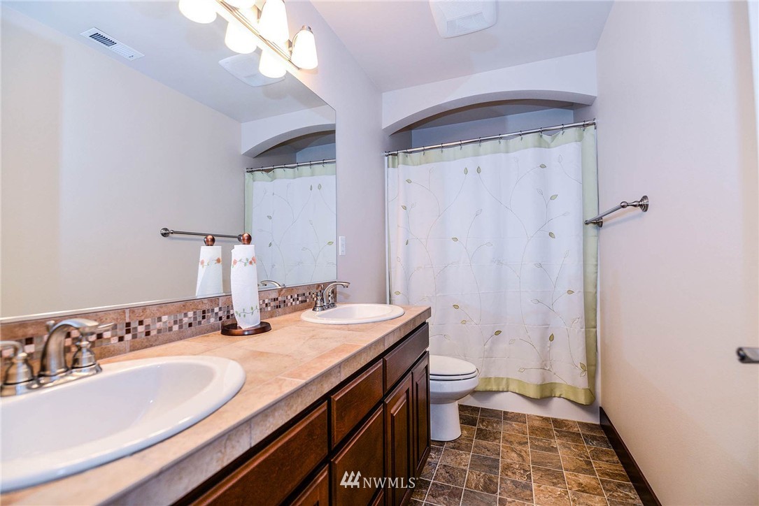 4423 220th Street Southeast Bothell, WA 98021 - Photo 21 of 24 a bathroom with a double vanity sink toilet and shower