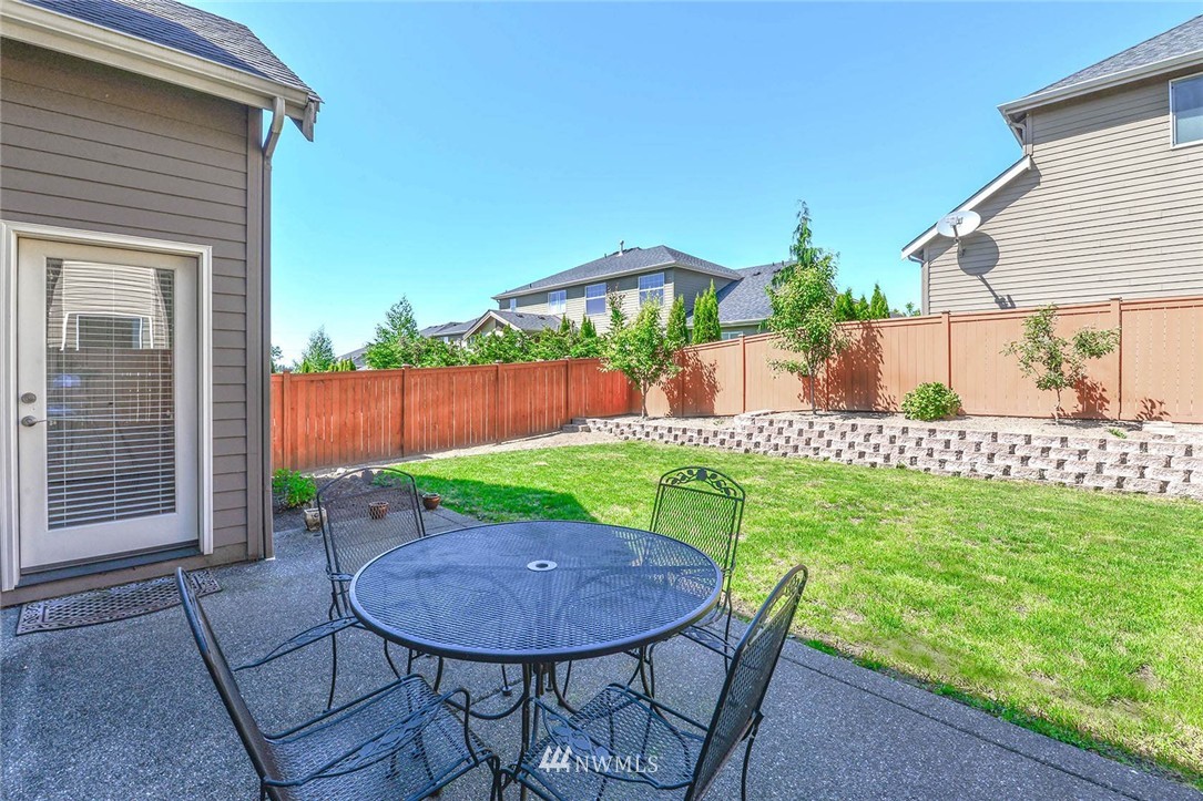 4423 220th Street Southeast Bothell, WA 98021 - Photo 24 of 24 a view of a chair and table in backyard of the house