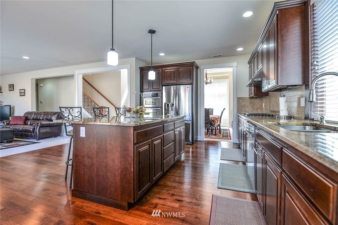 4423 220th Street Southeast Bothell, WA 98021 - Photo 8 of 24 a kitchen with stainless steel appliances granite countertop a stove a sink dishwasher a refrigerator and a oven