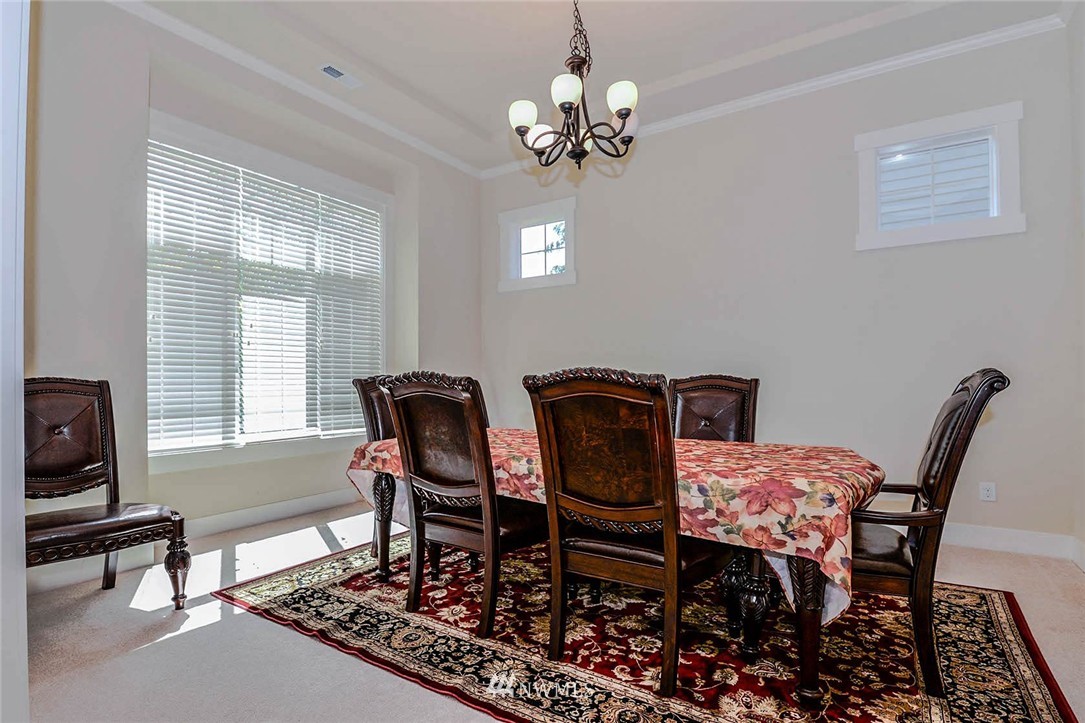 4423 220th Street Southeast Bothell, WA 98021 - Photo 9 of 24 a view of a dining room with furniture and chandelier