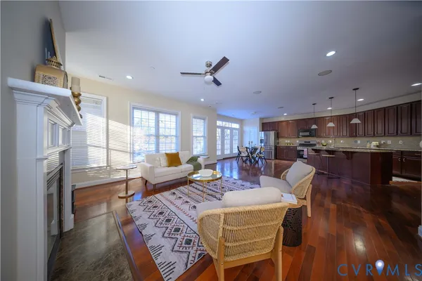 a living room with fireplace furniture and a wooden floor