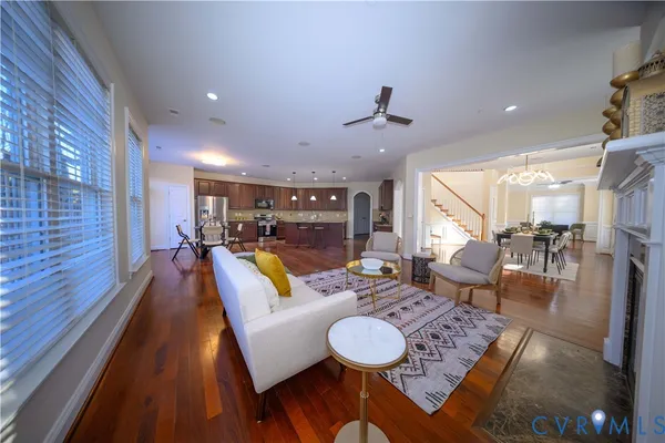 a living room with furniture and kitchen view