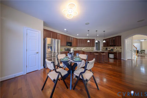 a view of a dining room with furniture and wooden floor