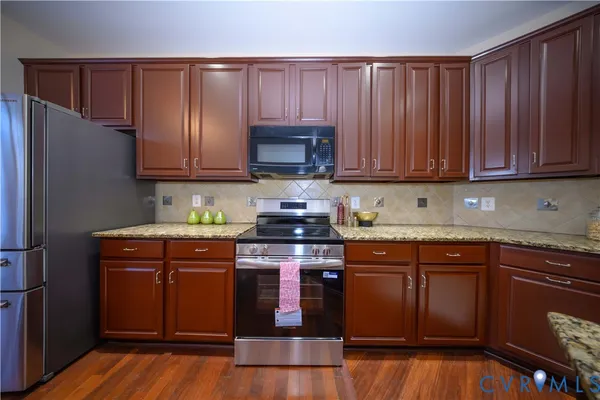 a kitchen with wooden cabinets and a stove top oven