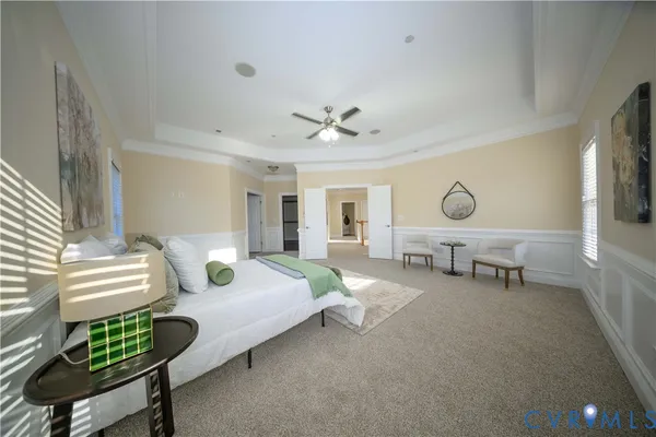 a spacious bedroom with a bed and a chandelier