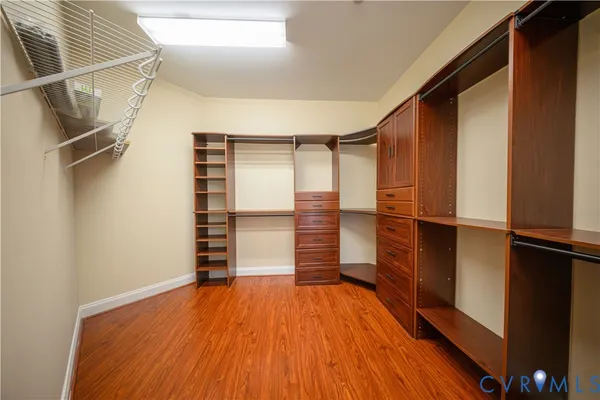 a view of walk in closet with empty racks
