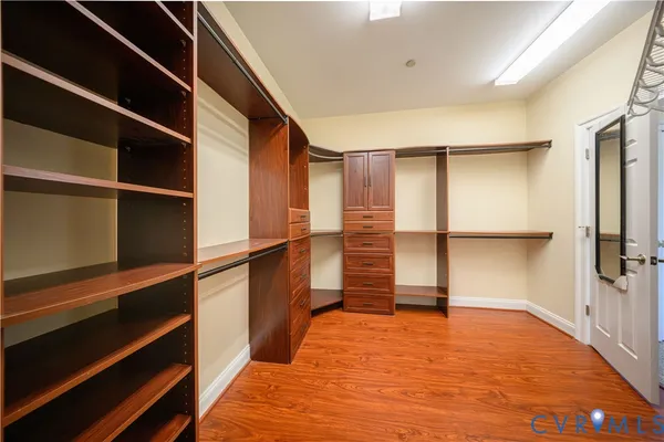 a view of walk in closet with empty racks
