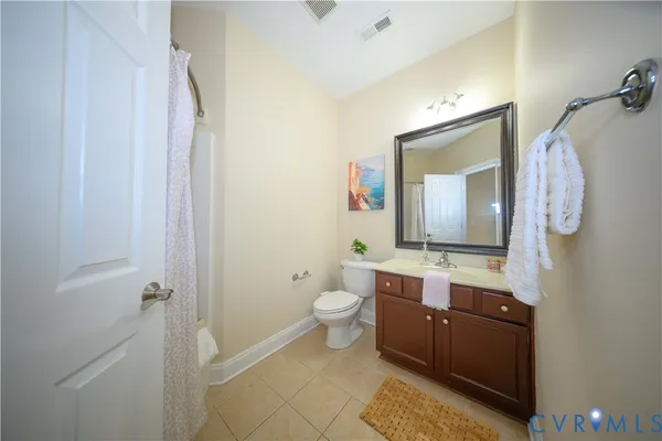 a bathroom with a double vanity sink toilet mirror and shower