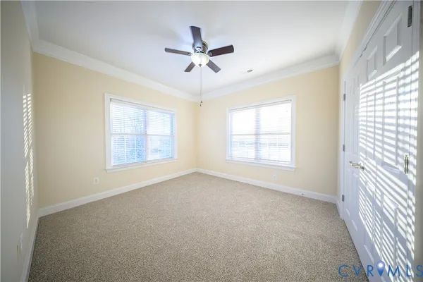 a view of a livingroom with a ceiling fan and window