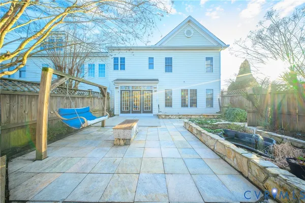 a view of a house with backyard and sitting area