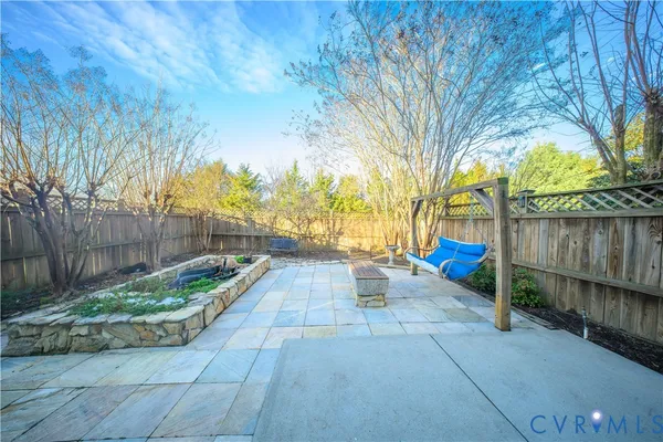 a view of a backyard with wooden fence