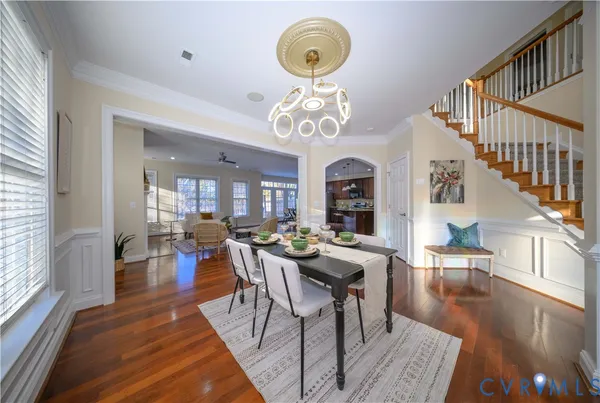 a view of a dining room with furniture wooden floor and chandelier