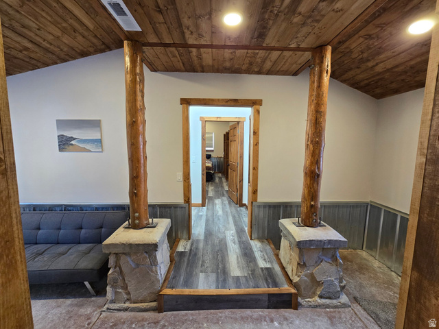 2029 West Tollgate Road Coalville, UT 84017 - Photo 29 of 36 Vaulted wood-finish ceiling, exposed timber structural columns, stone-clad column bases, wood-finish flooring, and recessed lighting