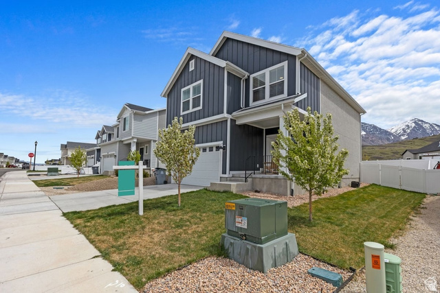 1323 South Raintree Lane Santaquin, UT 84655 - Photo 2 of 23 View of front of house featuring board and batten siding, a garage, concrete driveway, and a residential view