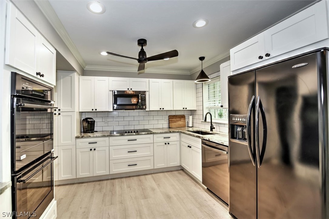 15180 Briar Ridge Circle Fort Myers, FL 33912 - Photo 13 of 35 a kitchen with stainless steel appliances a refrigerator sink and microwave