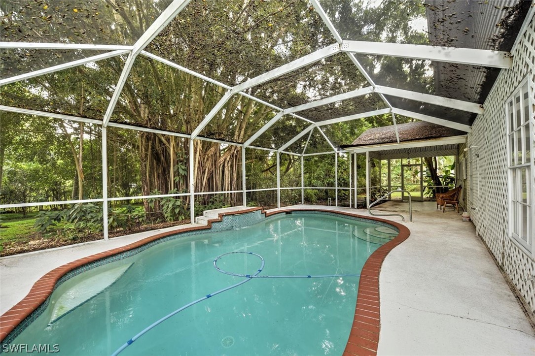 15180 Briar Ridge Circle Fort Myers, FL 33912 - Photo 17 of 35 a view of a swimming pool with a porch