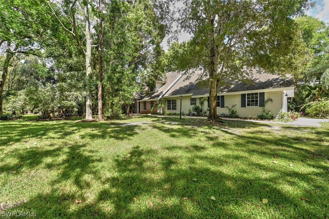 15180 Briar Ridge Circle Fort Myers, FL 33912 - Photo 3 of 35 a front view of a house with a yard