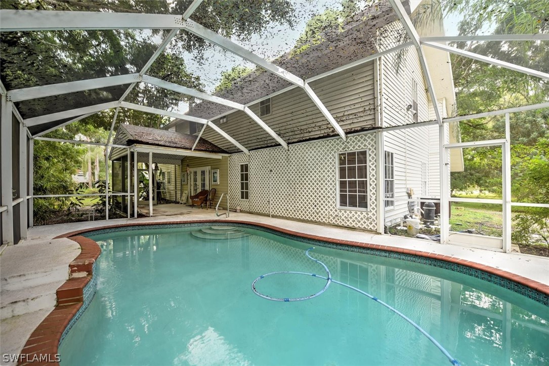 15180 Briar Ridge Circle Fort Myers, FL 33912 - Photo 32 of 35 a view of a backyard with a swimming pool