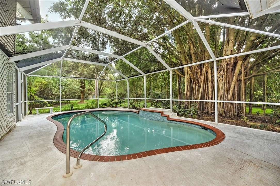 15180 Briar Ridge Circle Fort Myers, FL 33912 - Photo 34 of 35 a view of a swimming pool with a yard